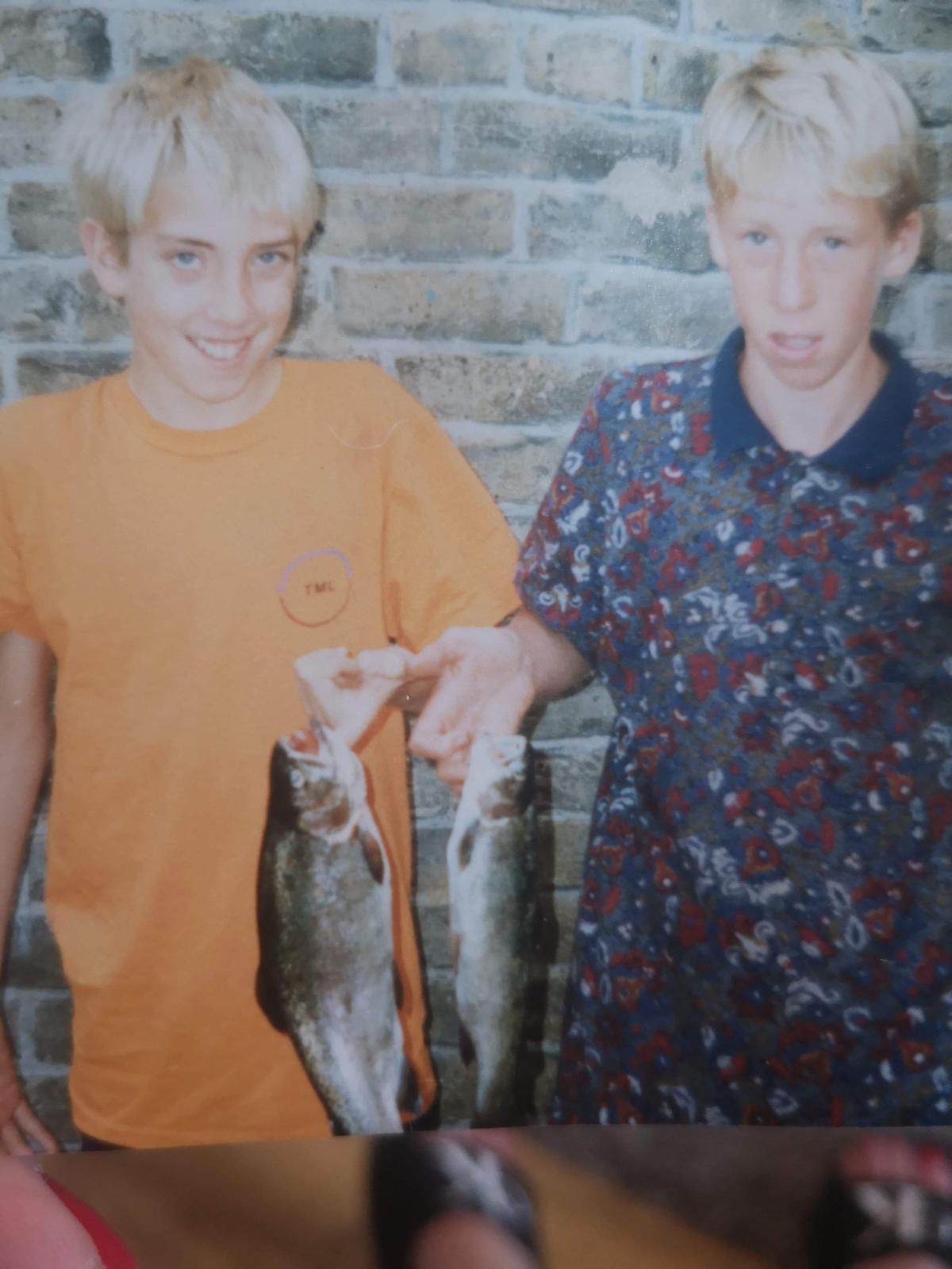 Baz and Ben holding fish as children